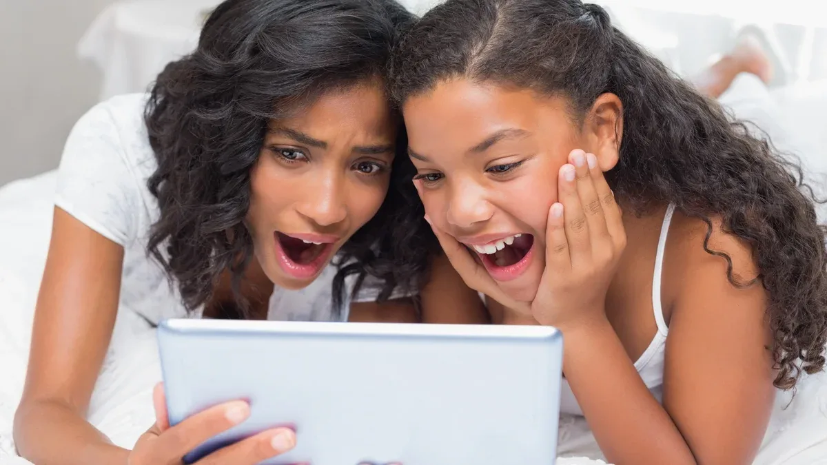 Surpris mère et fille en utilisant une tablette ensemble