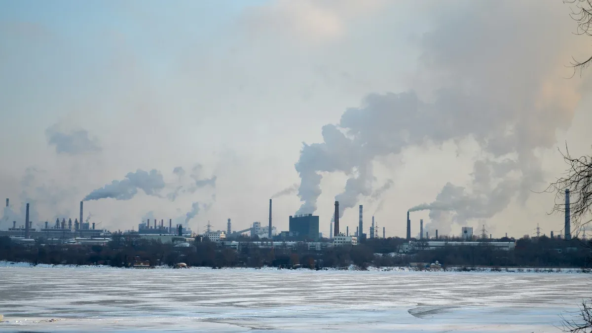 Usine de fumage ville de paysage industriel de rivière gelée avec pollution produite